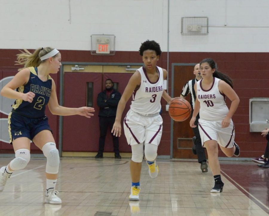 Senior Janesa Cockburn, center, and sophomore Blase Blakie, right, drive the ball at the Dwight Morrow home game vs. Indian Hills on January 9, 2020.