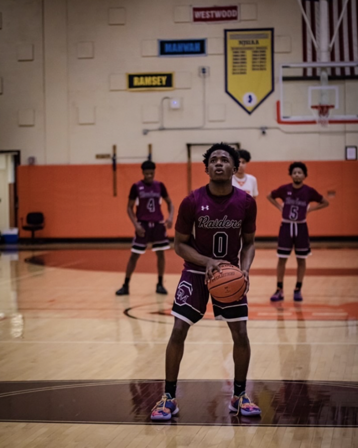 Seen above is senior guard Bertin Place, shooting a free throw against Dumont.